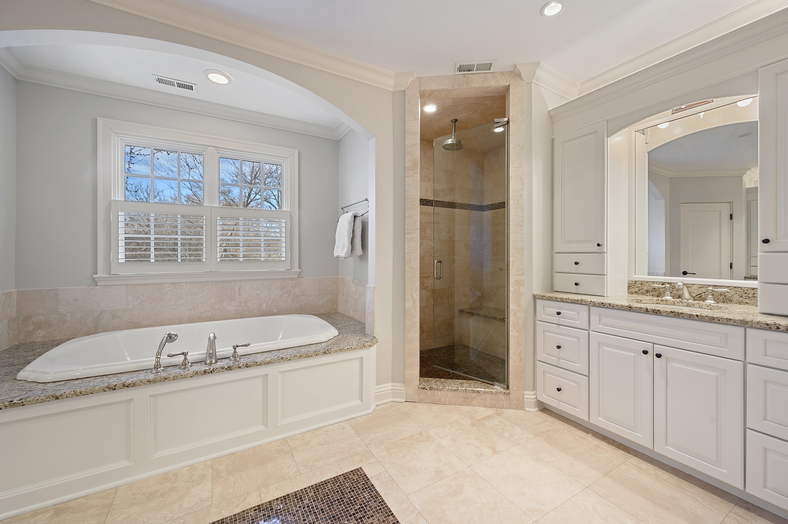 1435 Tower Road Winnetka, IL 60093 - Photo 26 of 34 a spacious bathroom with a tub sink shower and mirror