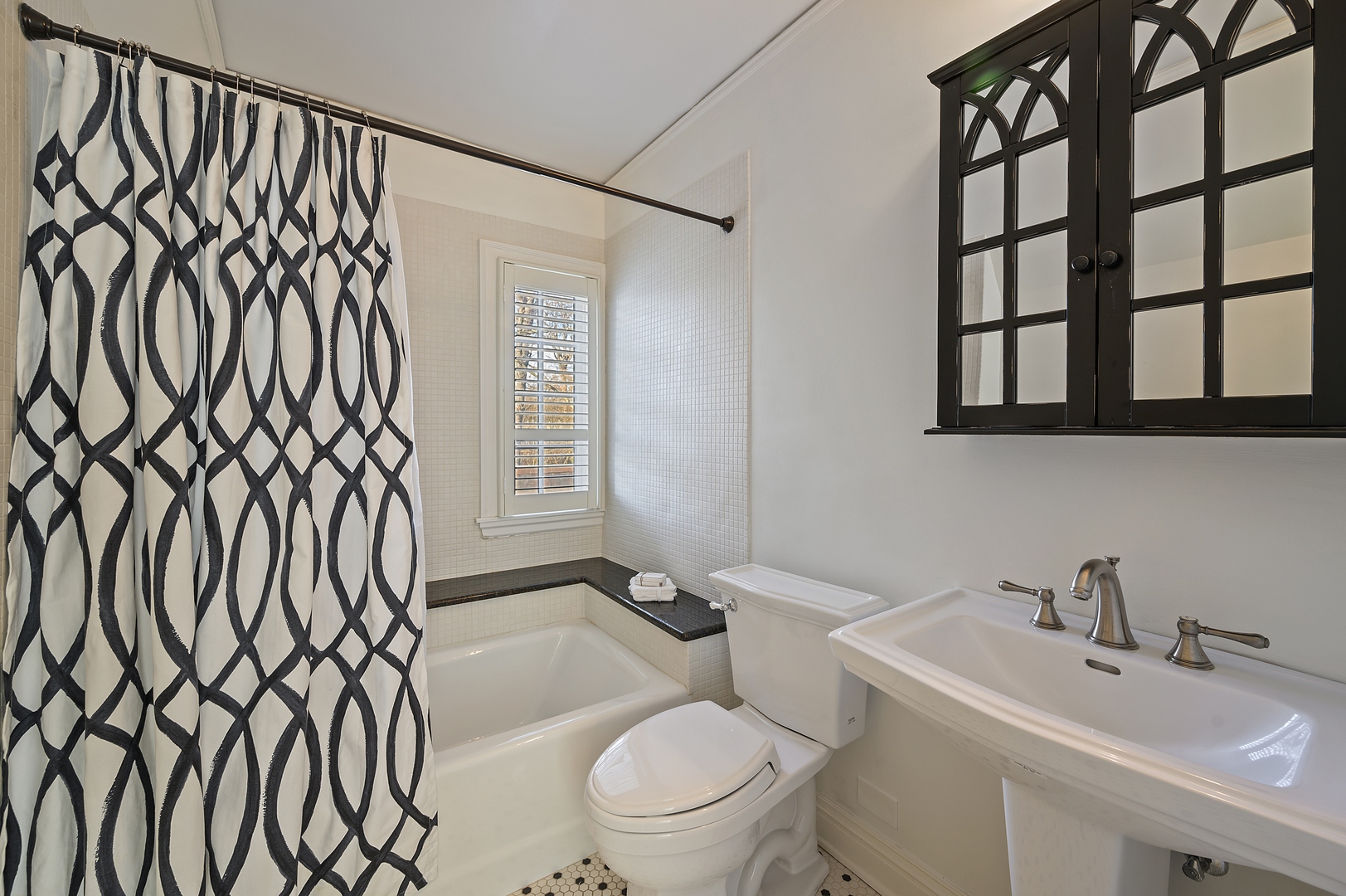 1435 Tower Road Winnetka, IL 60093 - Photo 30 of 34 a bathroom with a sink a toilet and a mirror