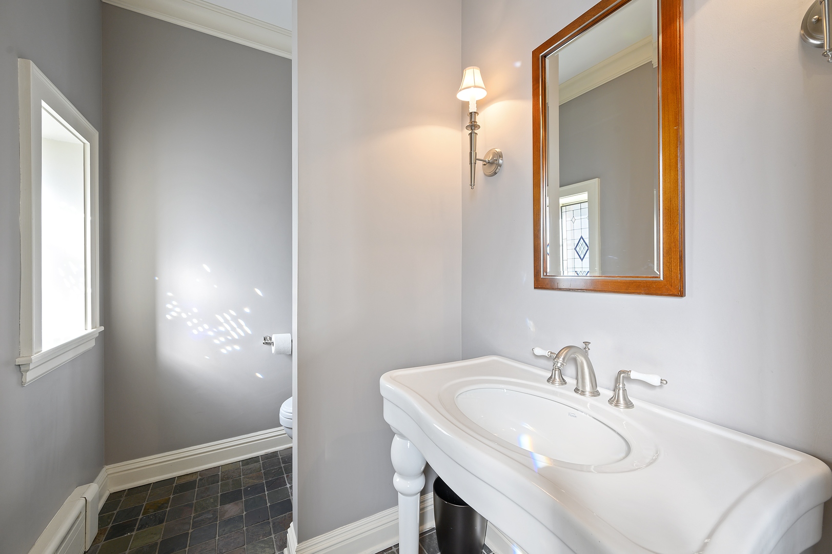 1435 Tower Road Winnetka, IL 60093 - Photo 5 of 34 a bathroom with a sink and a mirror