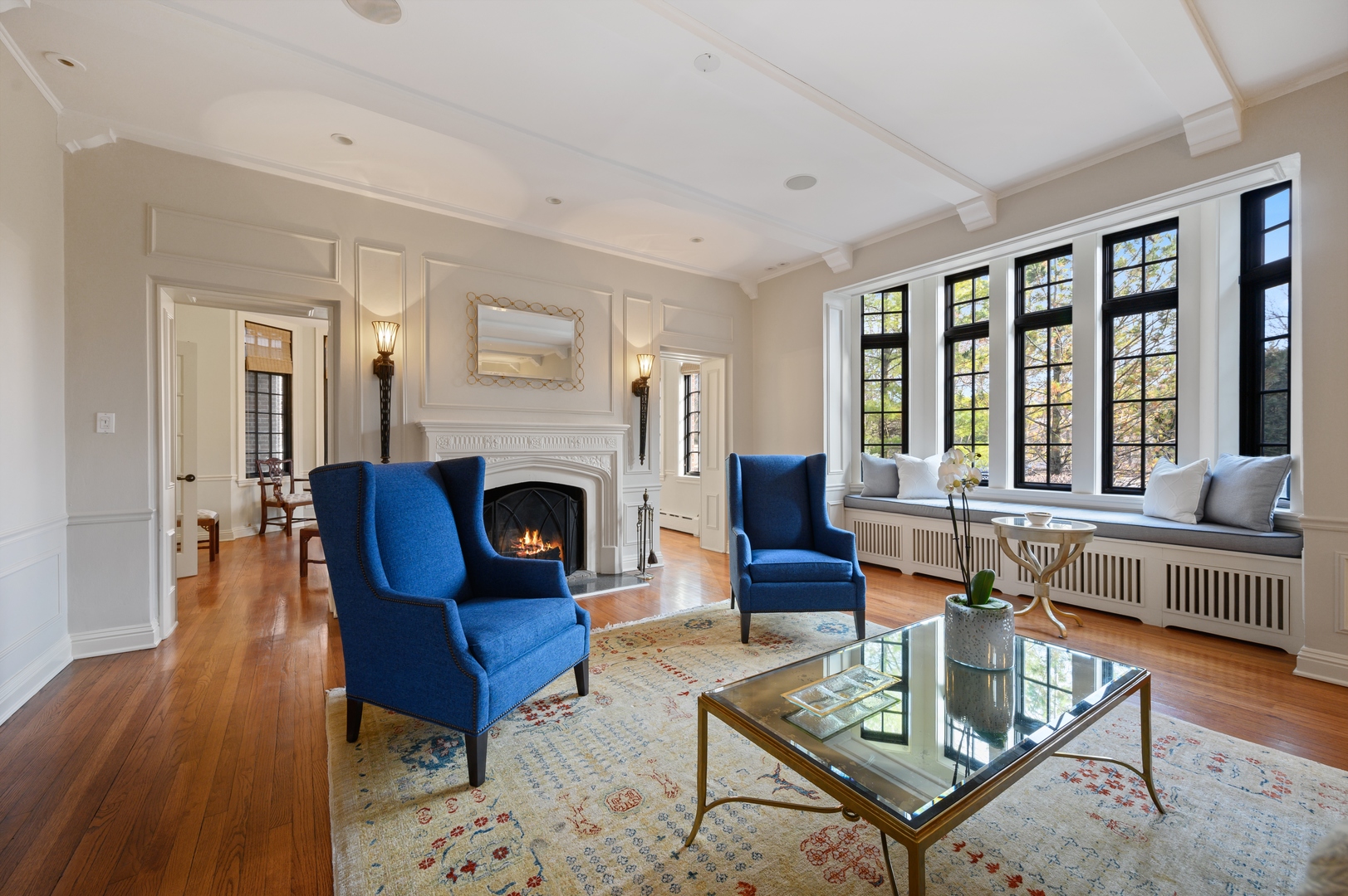 1435 Tower Road Winnetka, IL 60093 - Photo 6 of 34 a living room with furniture a fireplace and large windows