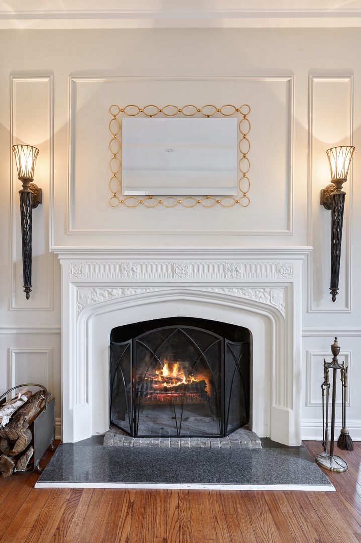 1435 Tower Road Winnetka, IL 60093 - Photo 7 of 34 a living room with a fireplace a rug and a fireplace