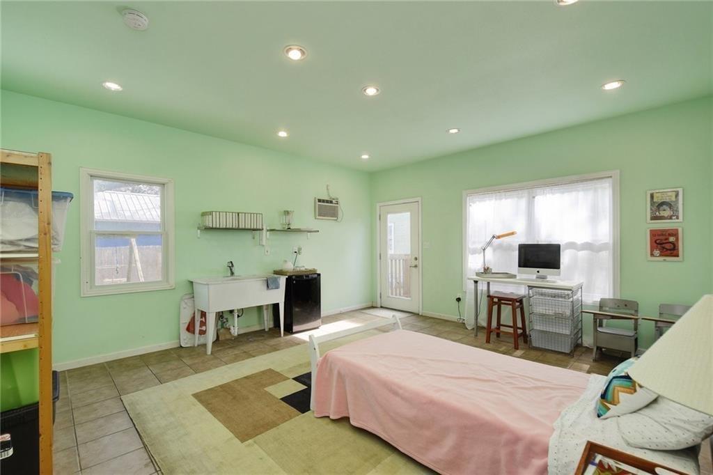 4412 Barrow Avenue, Unit A Austin, TX 78751 - Photo 16 of 28 Tiled bedroom with access to outside, recessed lighting, multiple windows, and a wall mounted air conditioner