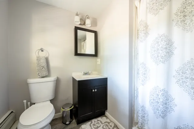a bathroom with a toilet sink and mirror