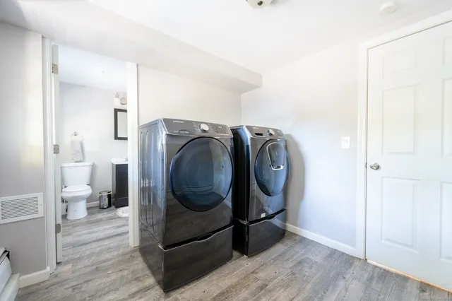 a utility room with sink dryer and washer