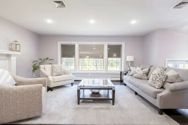 a living room with furniture and a large window