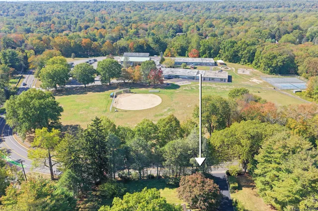 a view of a swimming pool with a patio and a yard
