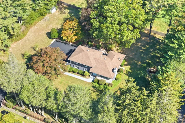 an aerial view of a house with swimming pool and garden view