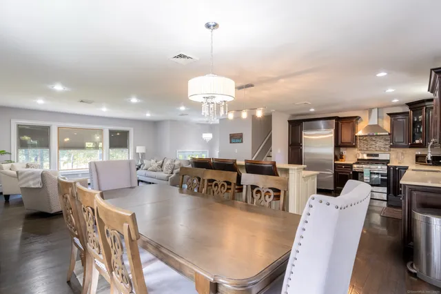 a living room with lots of furniture and a chandelier