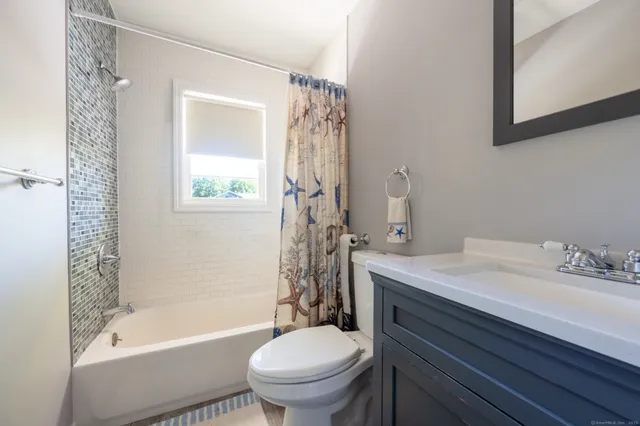 a bathroom with a sink toilet tub and shower
