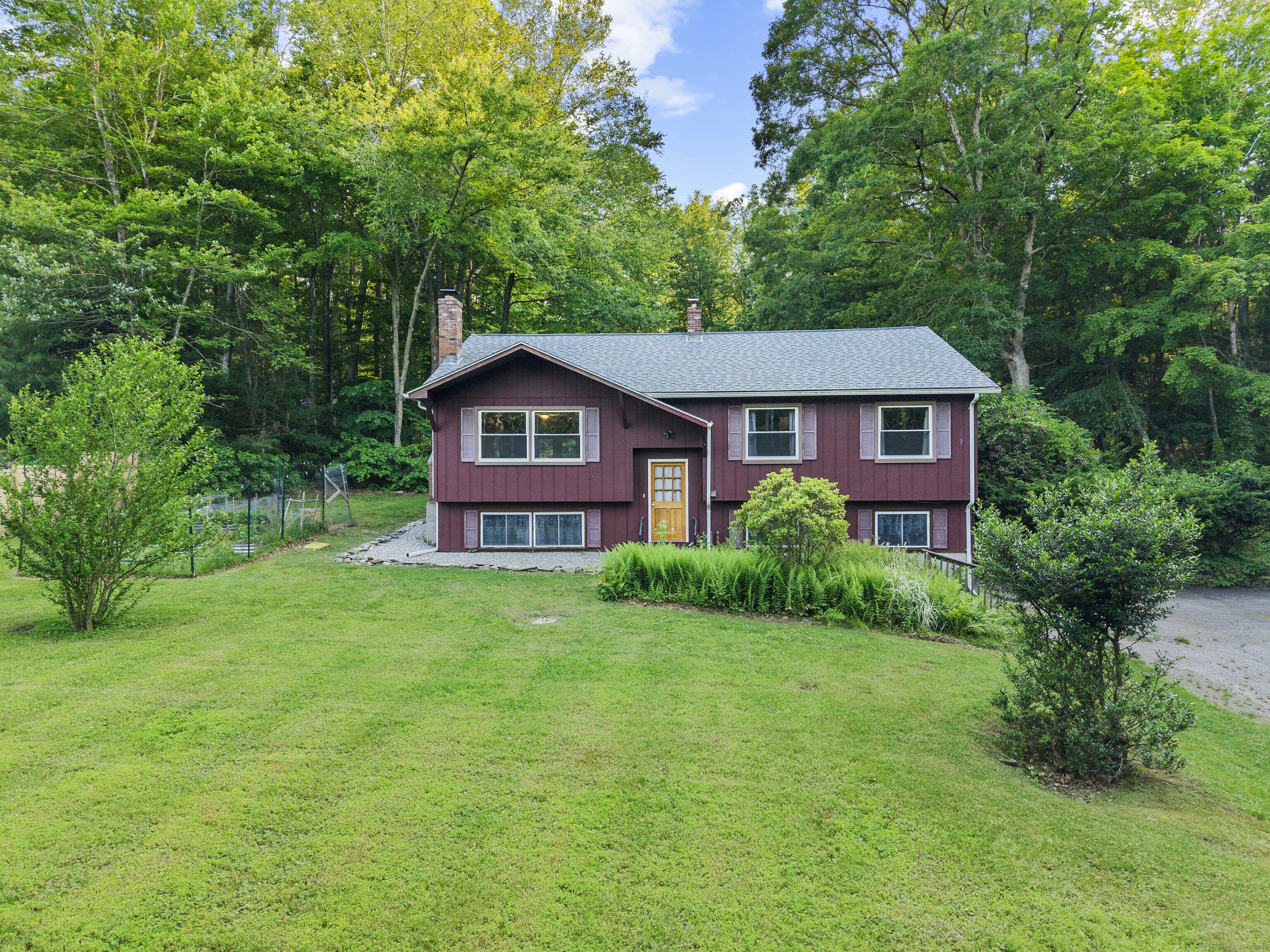 9 Phillip Lane Ledyard, CT 06339 - Photo 1 of 1 a front view of a house with a yard and trees