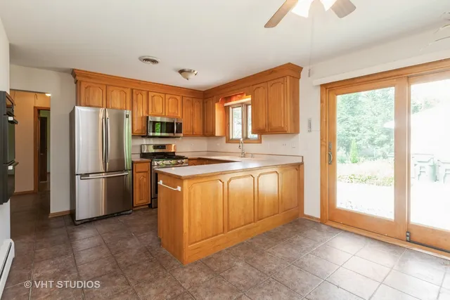 a kitchen with stainless steel appliances granite countertop a refrigerator stove top oven a sink and dishwasher