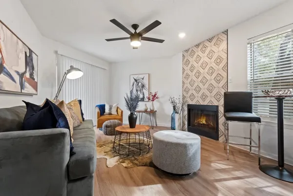 a living room with furniture and a fireplace