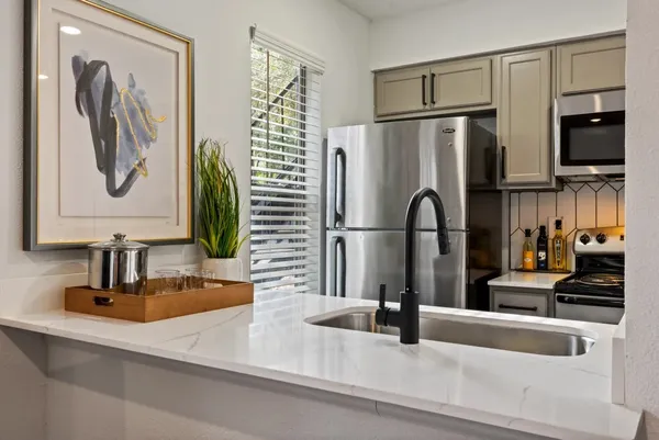 a kitchen with a refrigerator and a sink