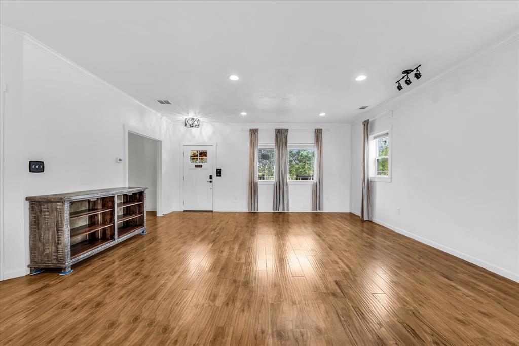 348 Barker Lane Waco, TX 76705 - Photo 5 of 39 an empty room with wooden floor and windows