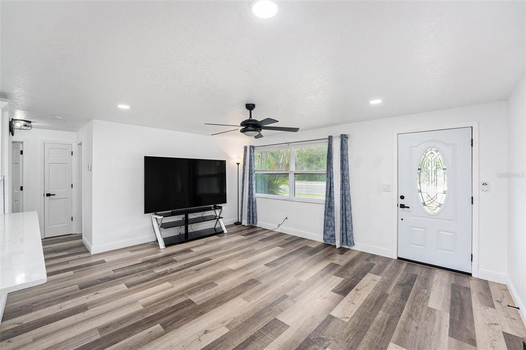1806 North Keene Road Clearwater, FL 33755 - Photo 11 of 35 a view of a livingroom with wooden floor and a flat screen tv