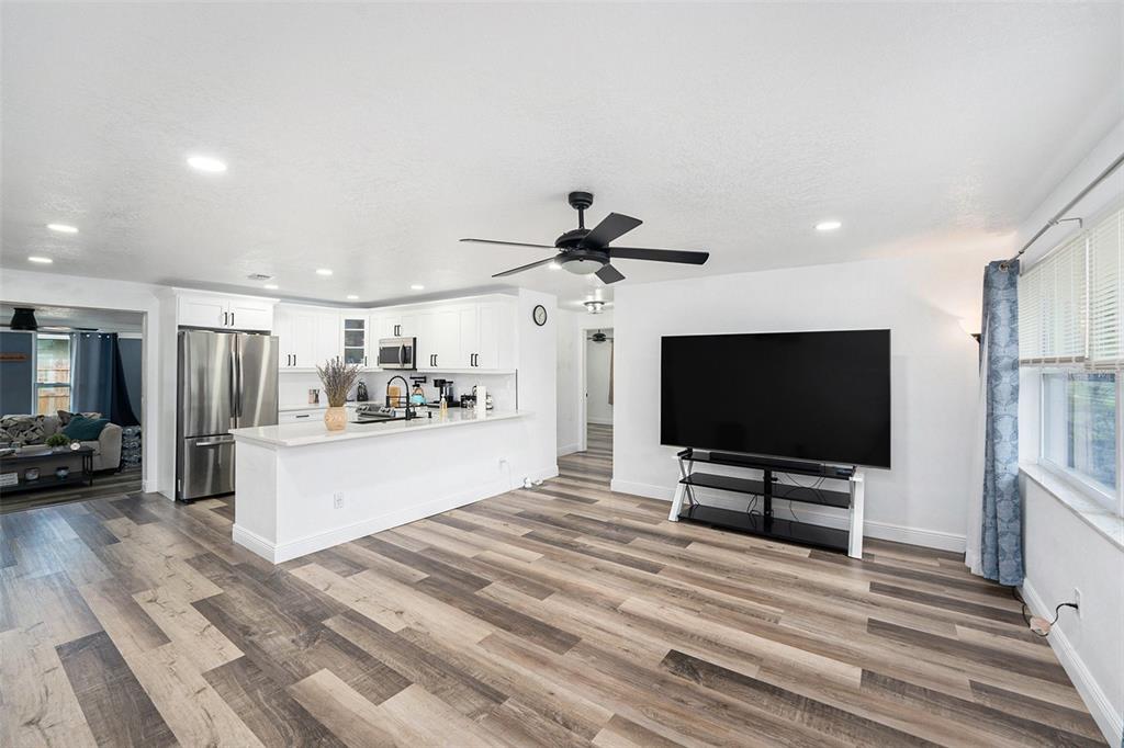 1806 North Keene Road Clearwater, FL 33755 - Photo 13 of 35 a view of a livingroom with kitchen and furniture
