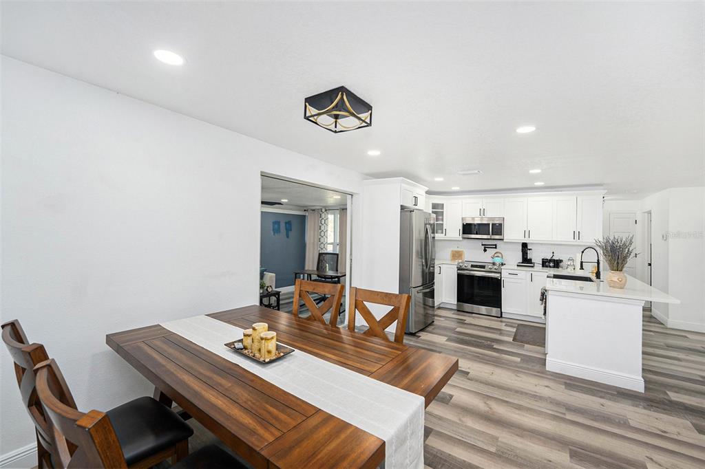 1806 North Keene Road Clearwater, FL 33755 - Photo 14 of 35 a view of a dining room with furniture and a kitchen