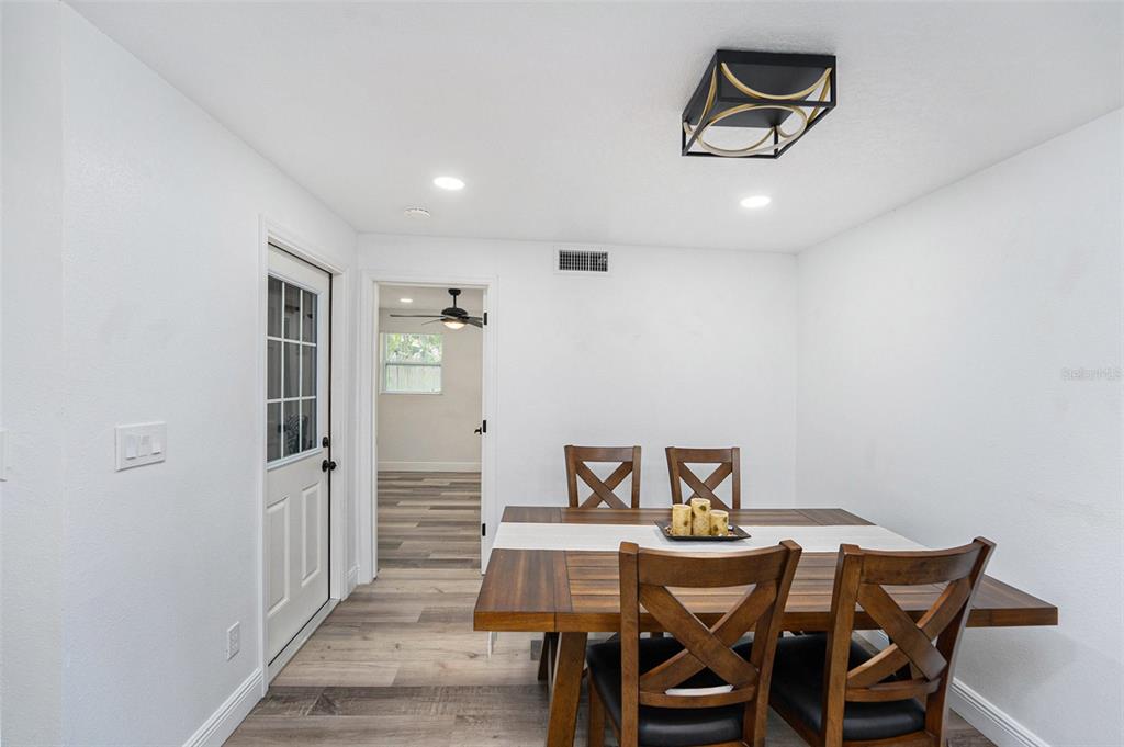 1806 North Keene Road Clearwater, FL 33755 - Photo 15 of 35 a view of a dining room with furniture and wooden floor