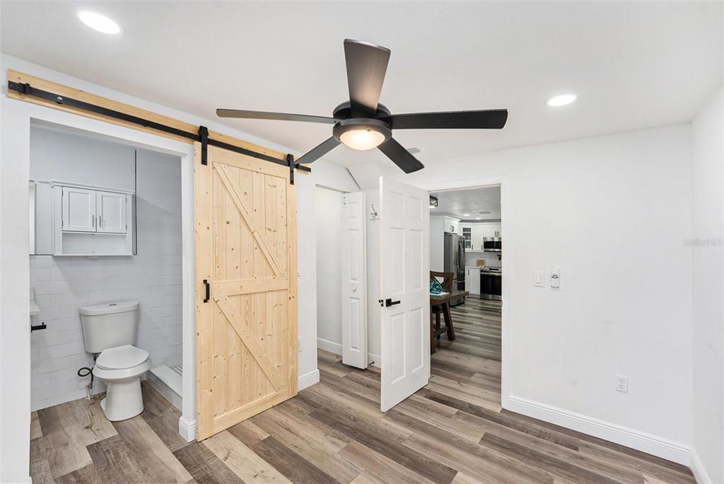 1806 North Keene Road Clearwater, FL 33755 - Photo 24 of 35 a view of a hallway with wooden floor and a bathroom