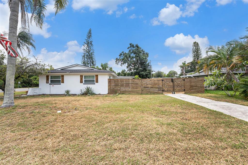1806 North Keene Road Clearwater, FL 33755 - Photo 10 of 35 a view of a house with a backyard and trees