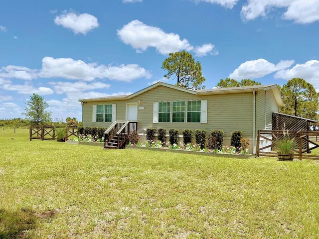 a view of a house with swimming pool and porch