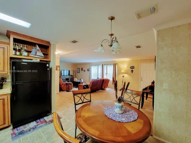 a living room with dining table and chairs