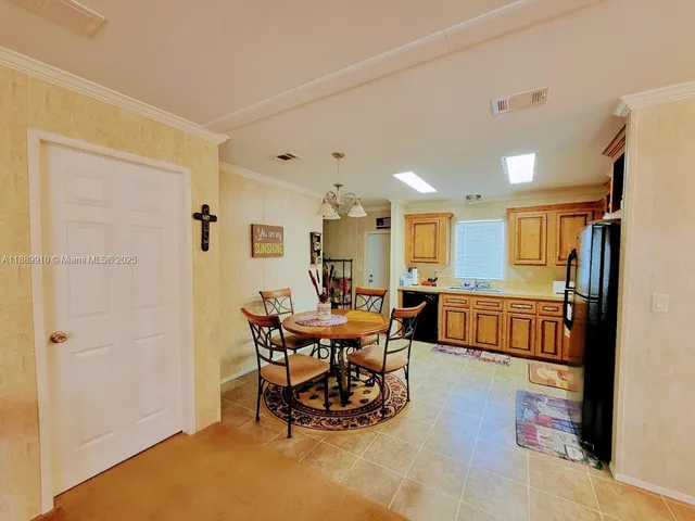 a dining room with furniture and a chandelier