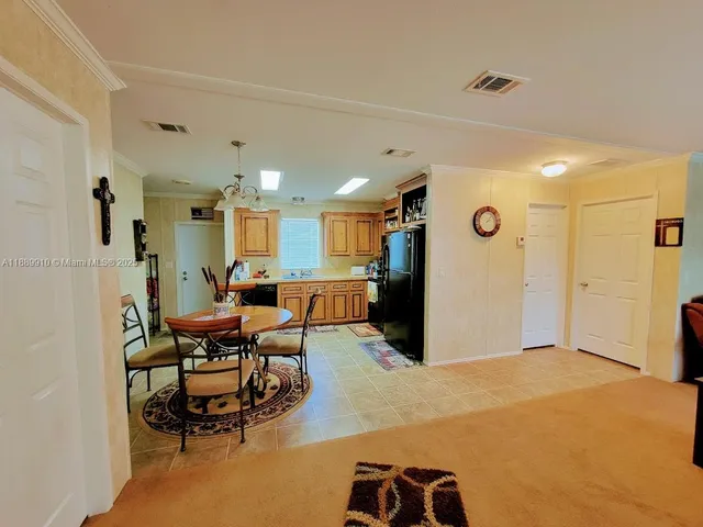 a living room with furniture and a dining table with wooden floor