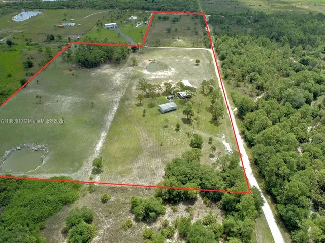 an aerial view of residential houses with outdoor space and swimming pool