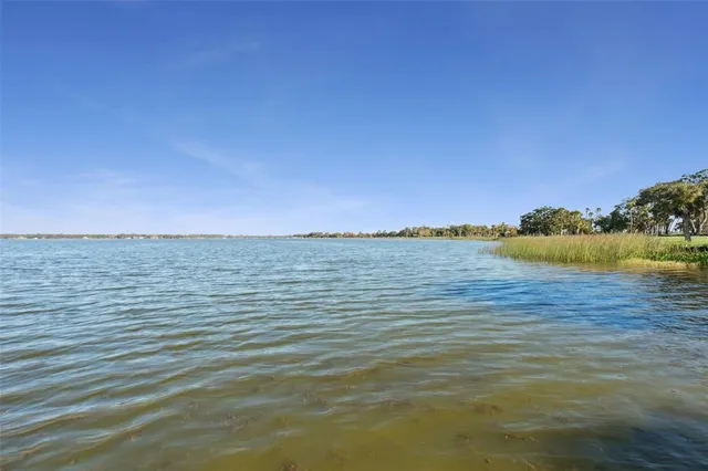 a kitchen with stainless steel appliances granite countertop a refrigerator a sink and white cabinets