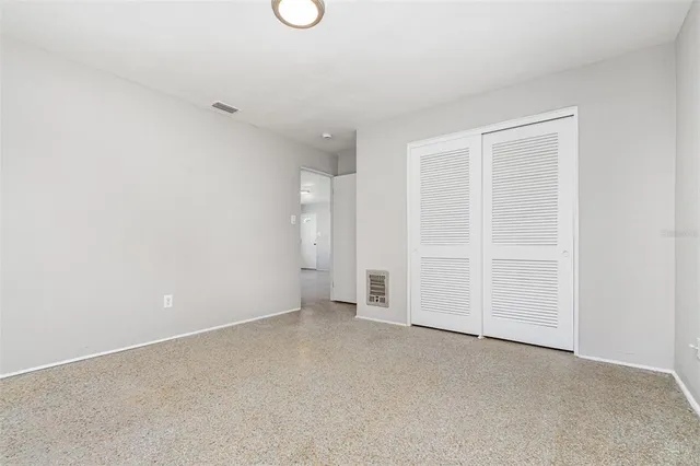 an empty room with closet area