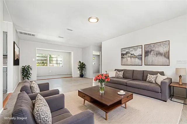 a living room with furniture and a large window