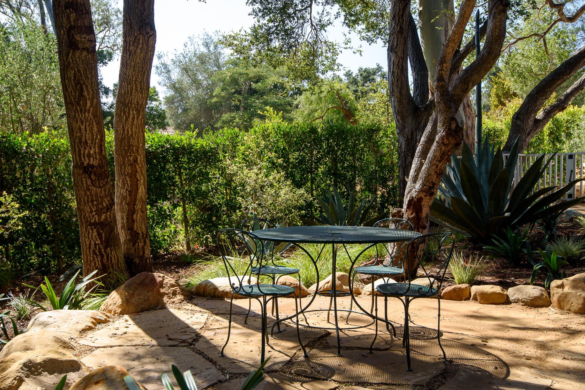765 B Hot Springs Road Montecito, CA 93108 - Photo 23 of 33 a view of backyard with a table and chairs under an umbrella