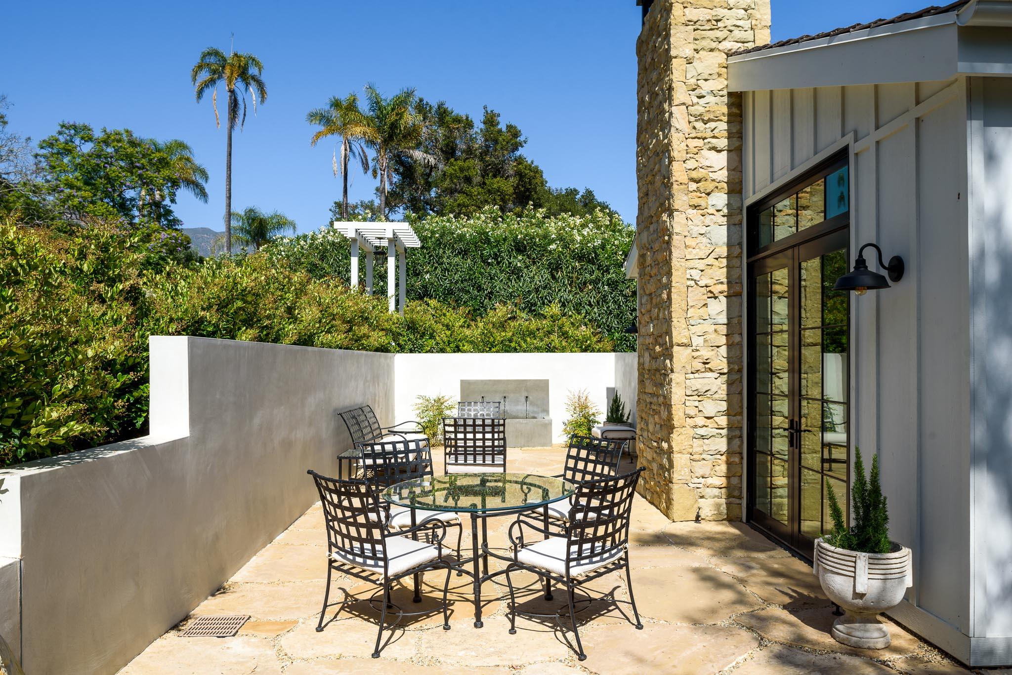 765 B Hot Springs Road Montecito, CA 93108 - Photo 32 of 33 a view of a patio with table and chairs and potted plants