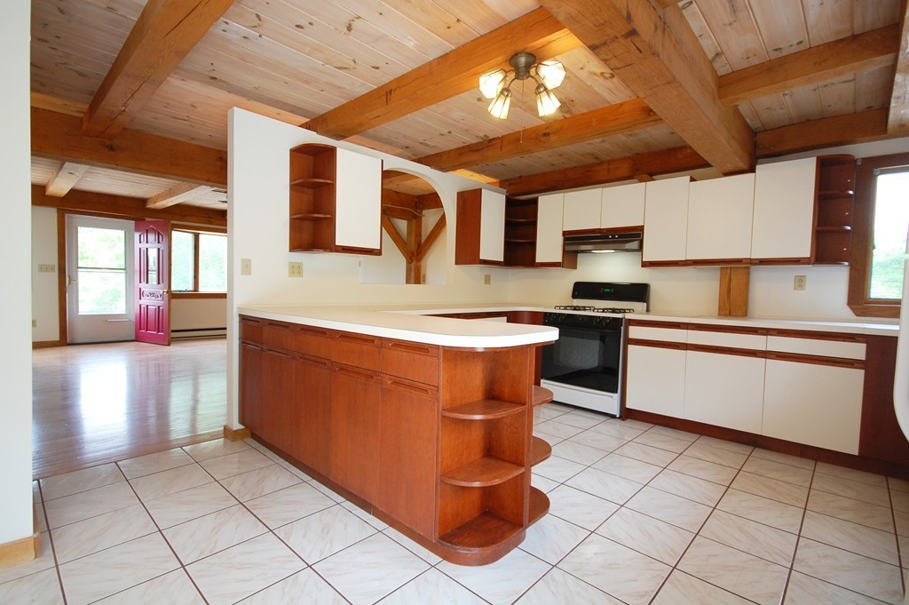 33 Osgood Road Sterling, MA 01564 - Photo 17 of 30 a kitchen with stainless steel appliances granite countertop a stove a sink and a microwave