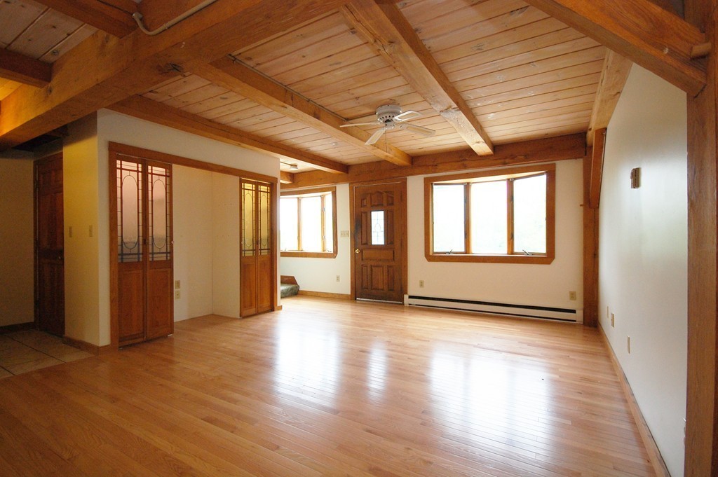 33 Osgood Road Sterling, MA 01564 - Photo 18 of 30 a view of an empty room with wooden floor and a window