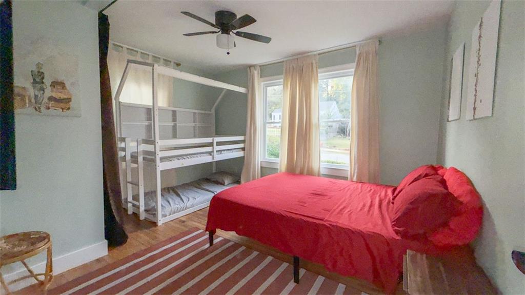 1450 Hawthorne Way East Point, GA 30344 - Photo 8 of 16 a bedroom with a bed and a chandelier