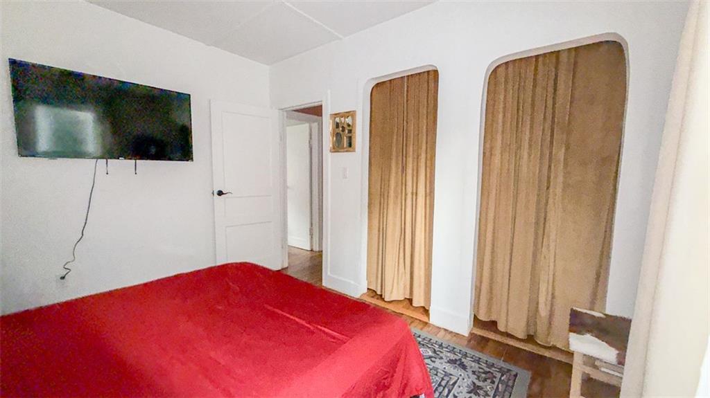 1450 Hawthorne Way East Point, GA 30344 - Photo 10 of 16 a bedroom with a bed and a flat screen tv