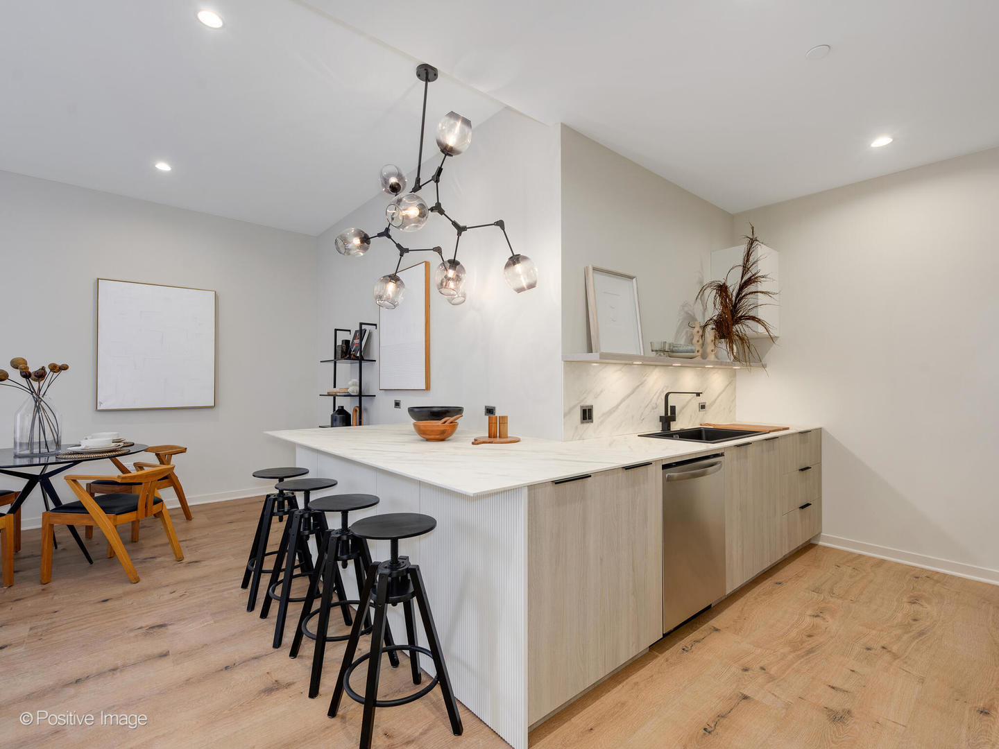 11 West Prospect Avenue, Unit 411 Mount Prospect, IL 60056 - Photo 11 of 71 a kitchen with stainless steel appliances a table and chairs in it