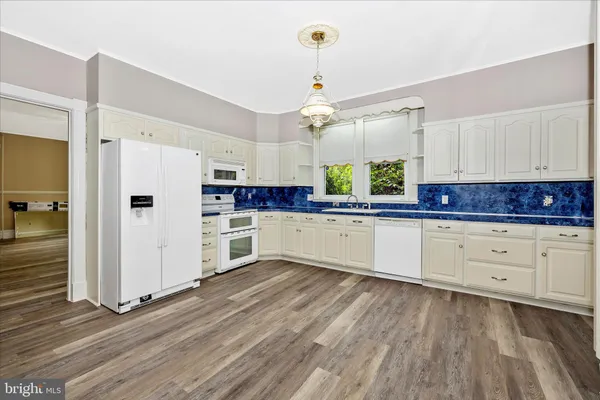 a view of an entryway with wooden floor