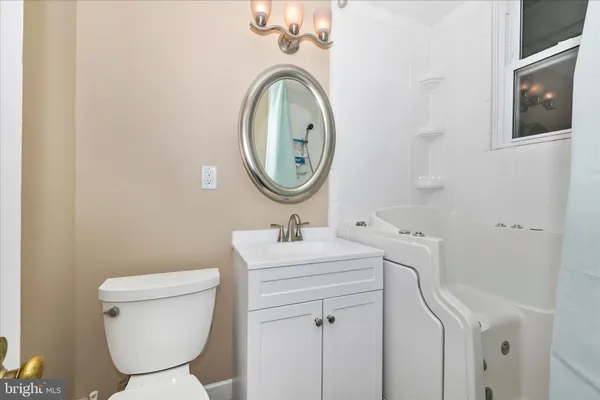 a view of a bathroom with a tub and a window