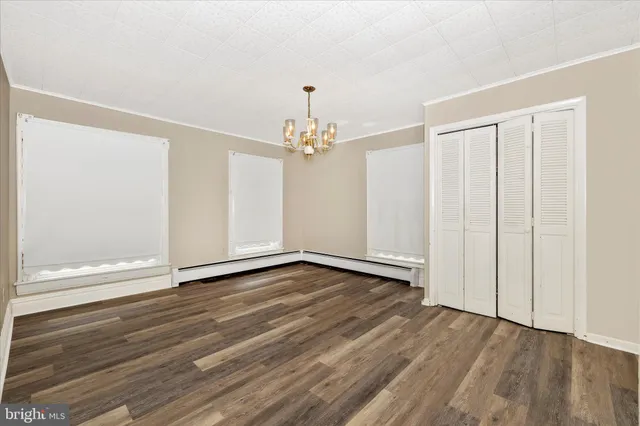 a view of a house with yard and sitting area