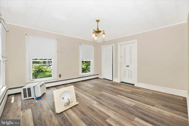 a front view of house with yard and car parked