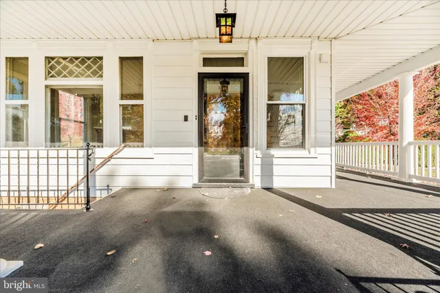 wooden floor fireplace and windows in an empty room