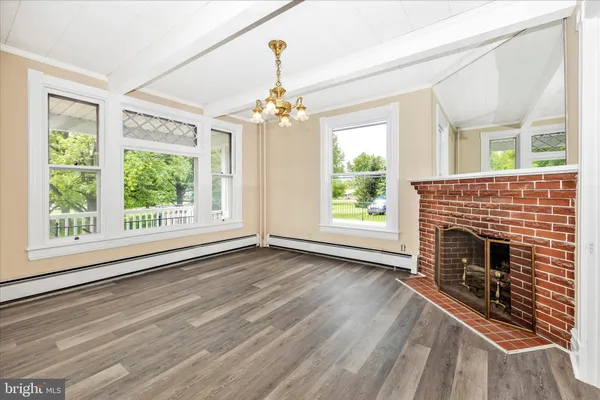 a view of a livingroom with wooden floor and fireplace