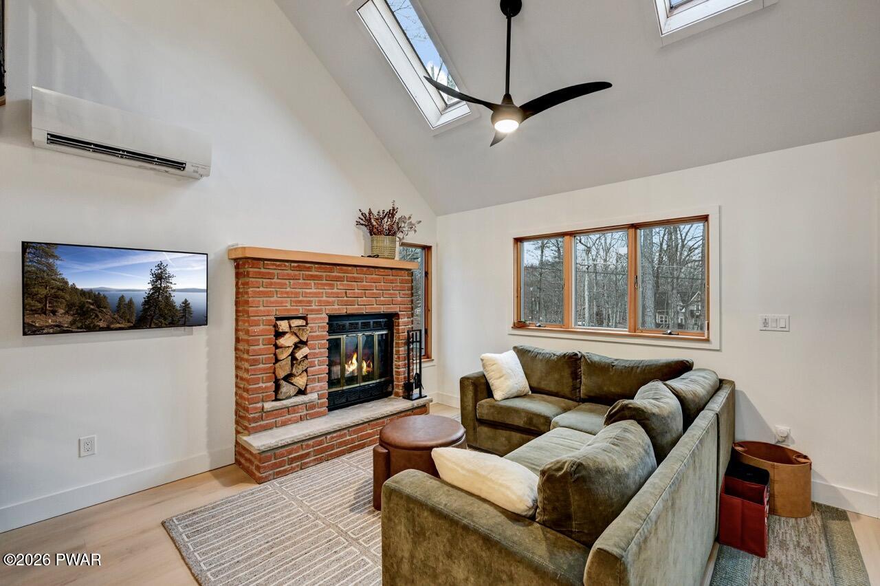 258 Lakeview Road Lackawaxen, PA 18435 - Photo 13 of 119 a living room with furniture and a fireplace