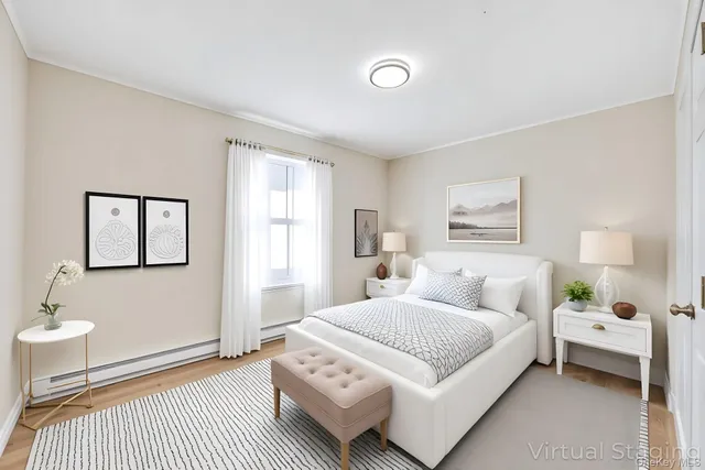 a bedroom with a bed a mirror and a large window