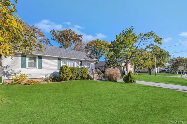 a view of a house with a big yard and potted plants
