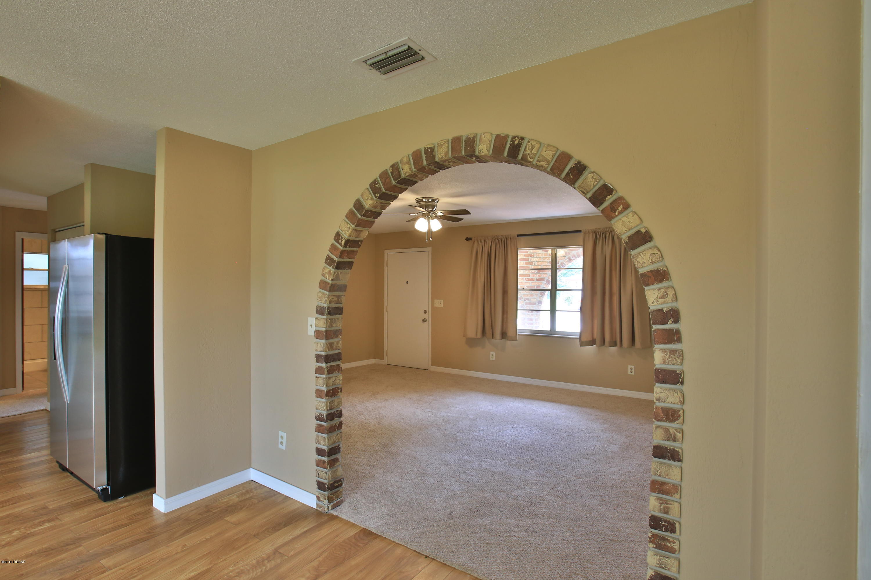 22 Raintree Drive Port Orange, FL 32127 - Photo 9 of 17 arched entrance to living room