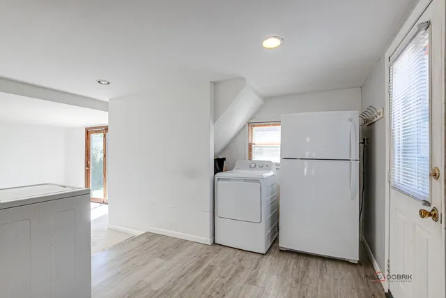 a utility room with cabinets washer and dryer